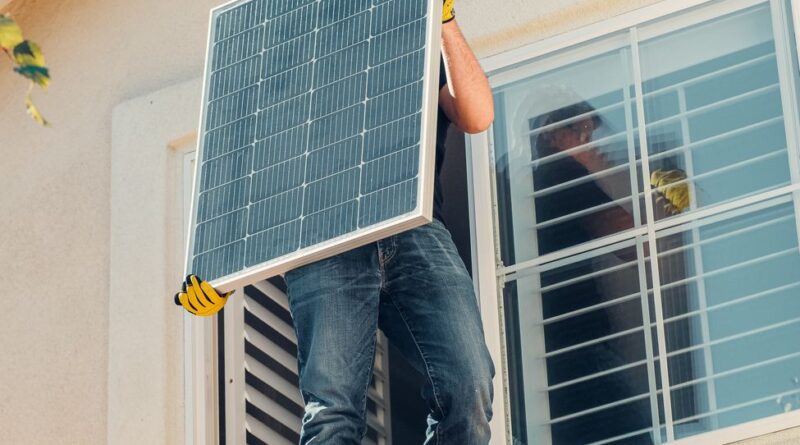 a man carrying solar panel